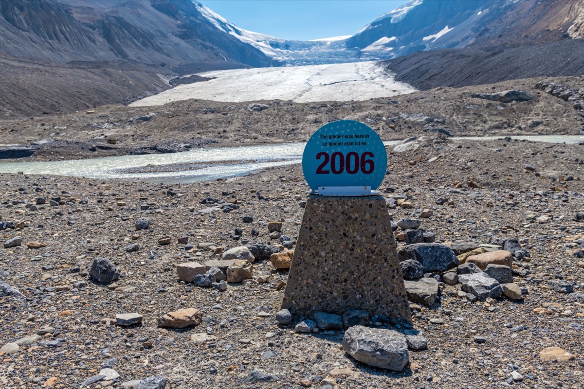 A retreating glacier, with a marker showing where the ice reached in 2006